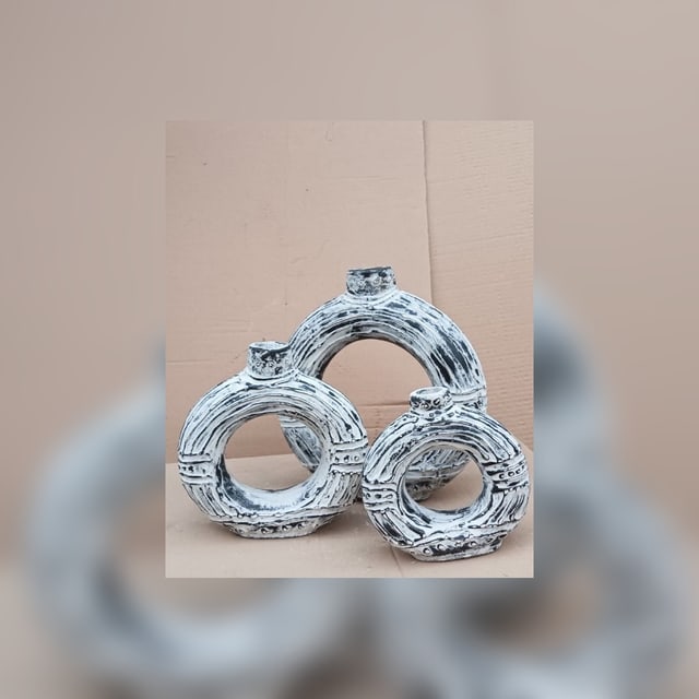 Textured white ceramic ring vessels